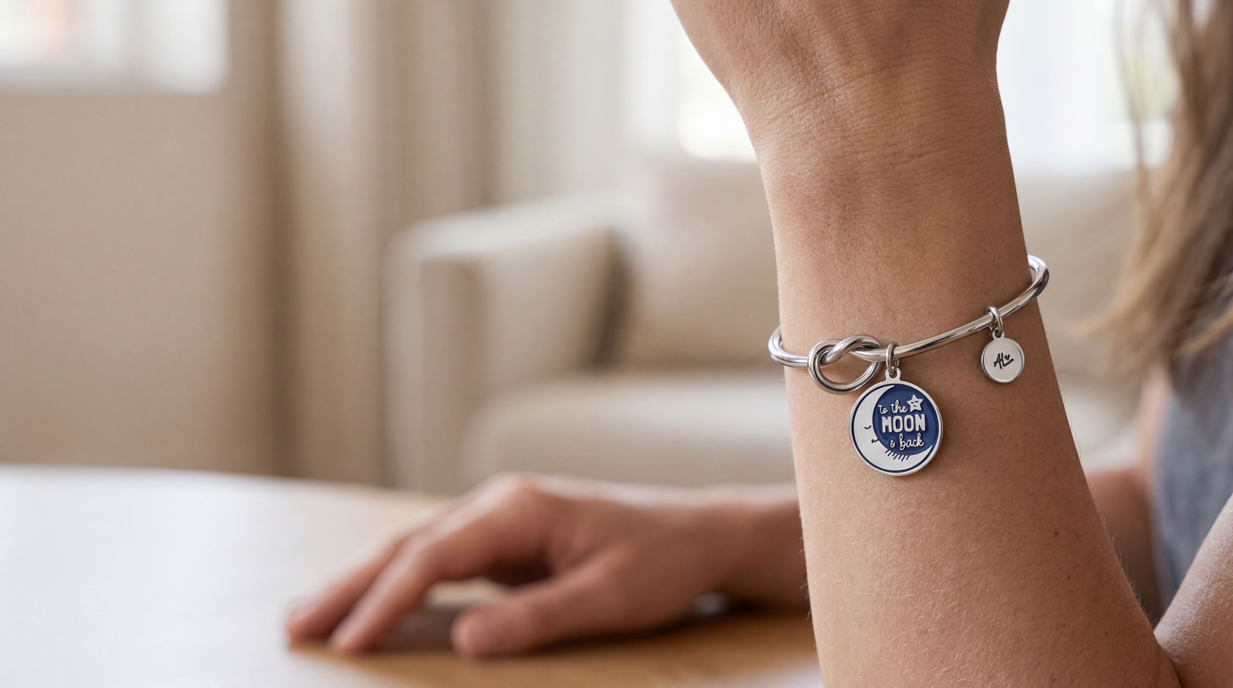 Adrienne Lee charm bracelet on the wrist