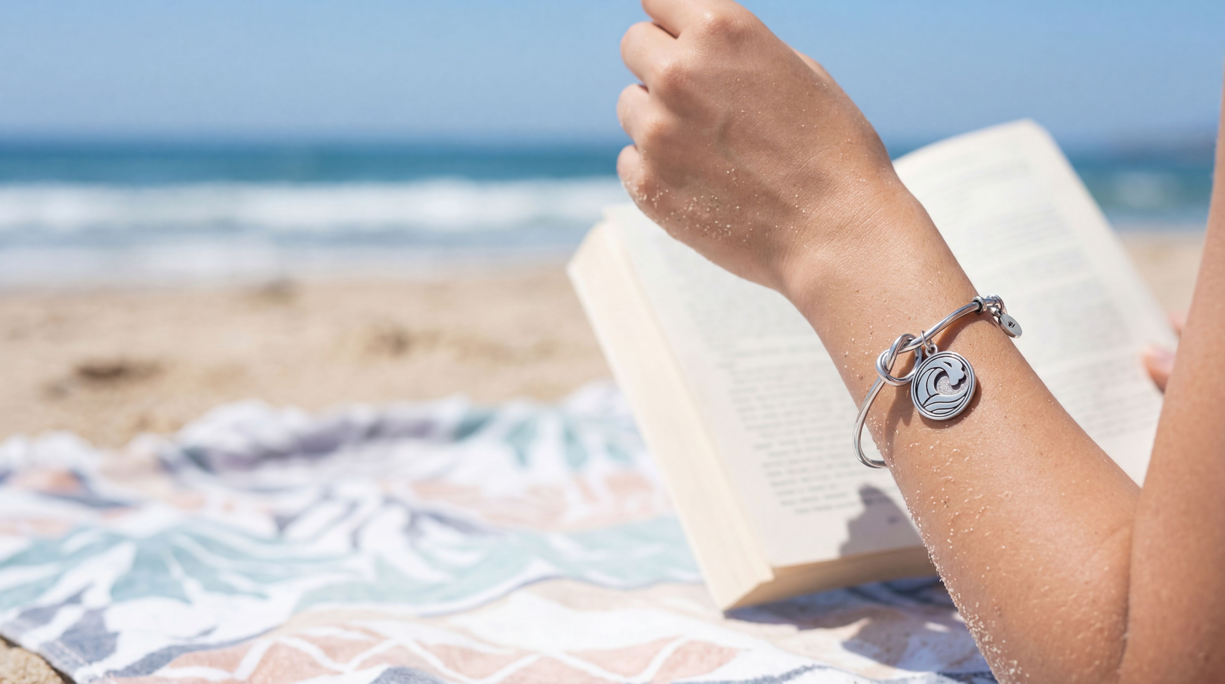 Adrienne Lee charm bracelet on the wrist